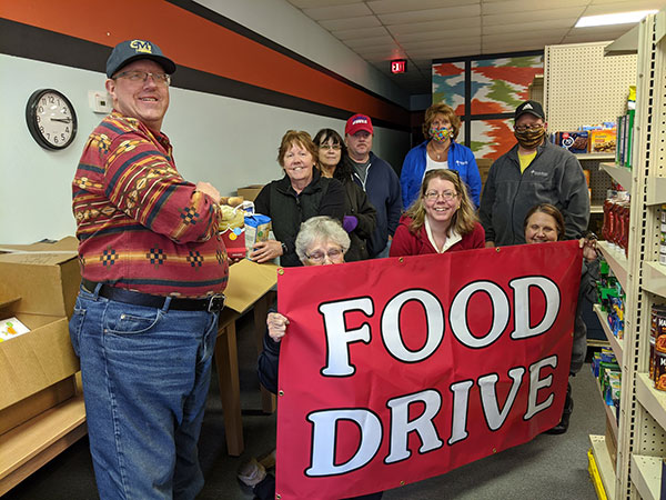 Group of people holding a food drive sign
